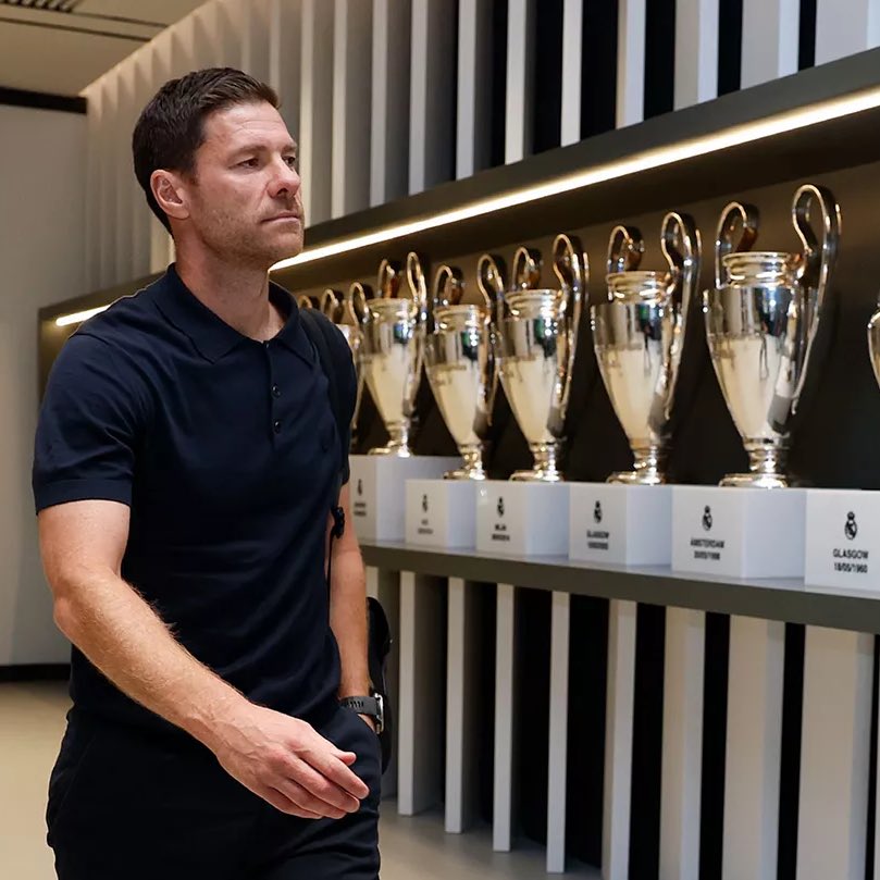 A person walking in front of a row of trophies

AI-generated content may be incorrect.
